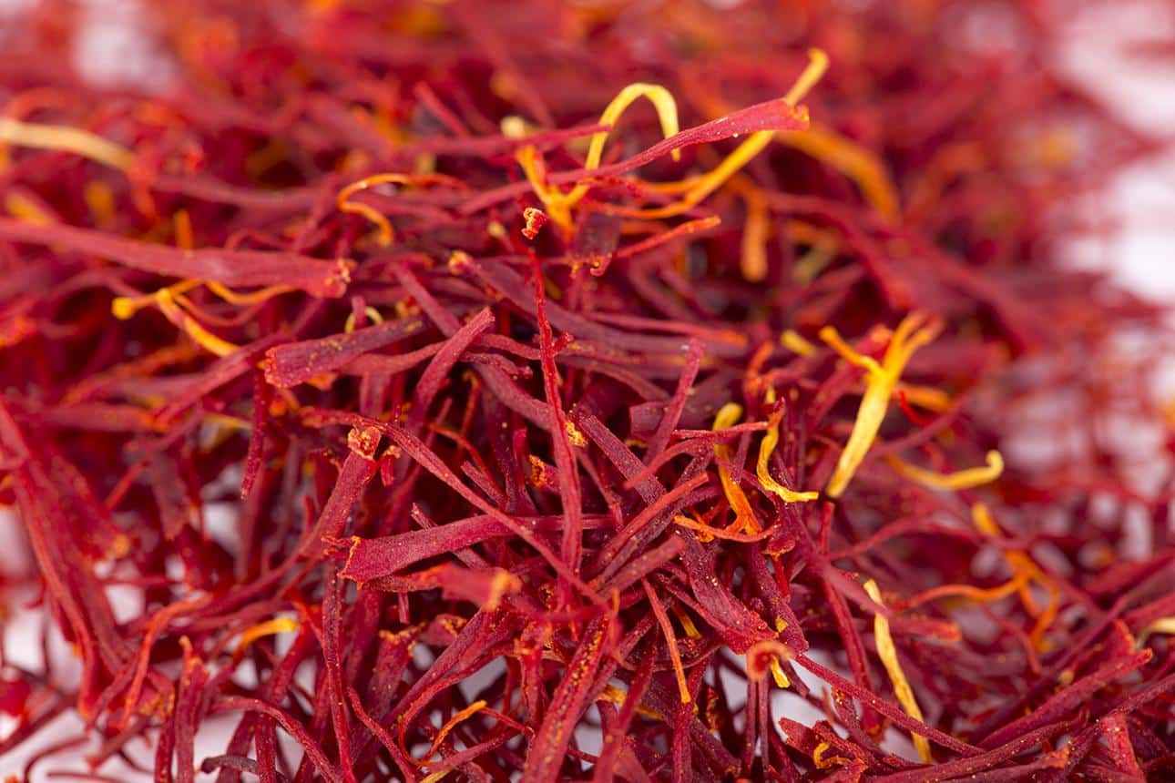 Premium Iranian Pushal saffron threads with natural yellow styles attached to red stigmas